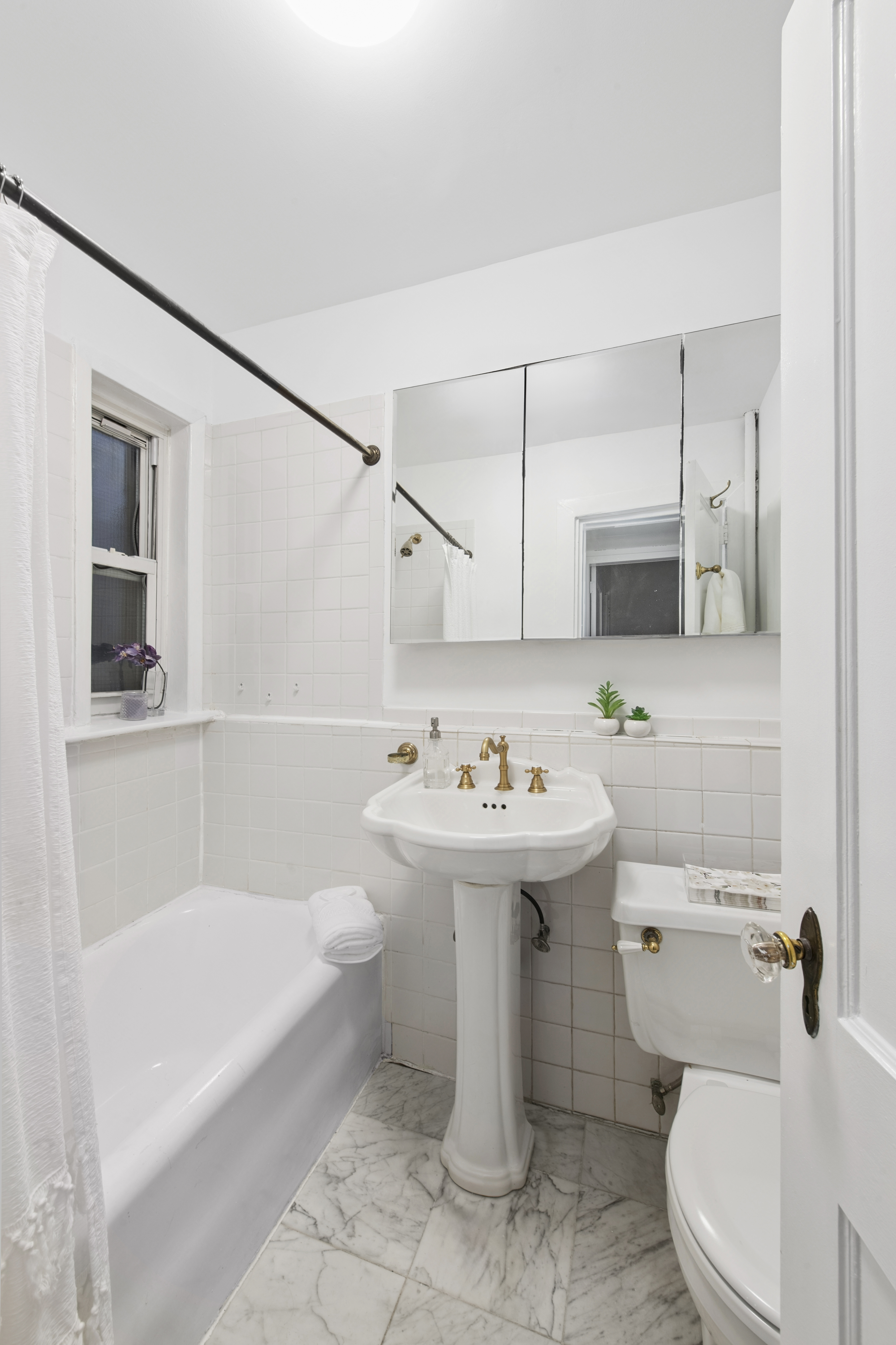 10 Pomander Walk, Unit 1 Manhattan, NY 10025 - Photo 8 of 13 a bathroom with a sink toilet and shower