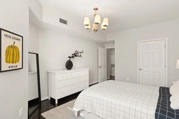 a bedroom with a bed and a chandelier