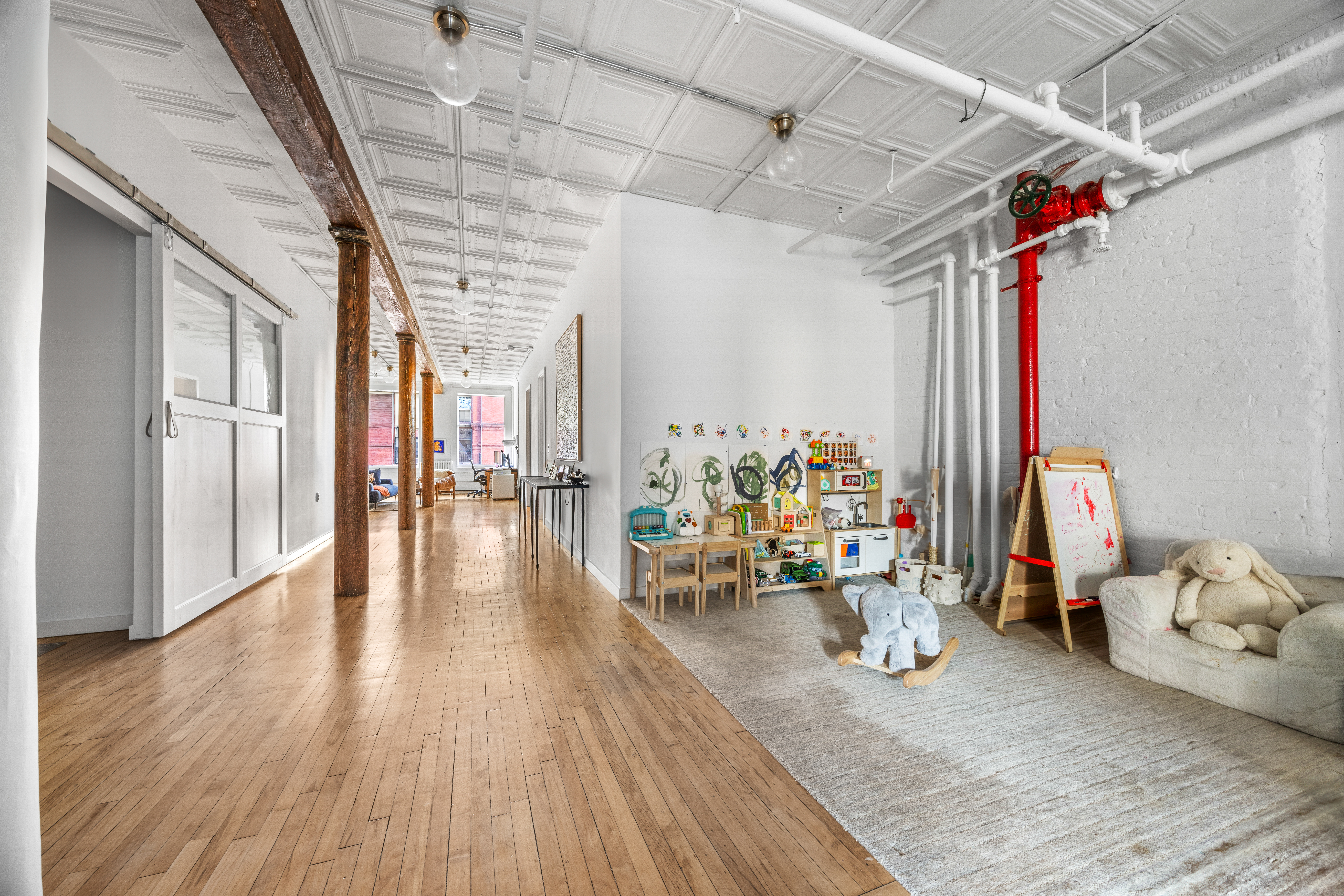 5 White Street, Unit 5B Manhattan, NY 10013 - Photo 12 of 21 a view of a room with lots of wooden furniture