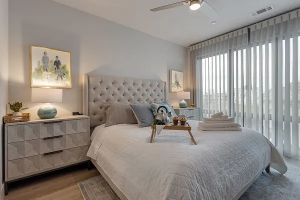 a bed sitting in a bedroom next to a window