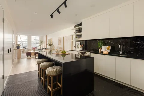 a kitchen with counter space dining table and chairs