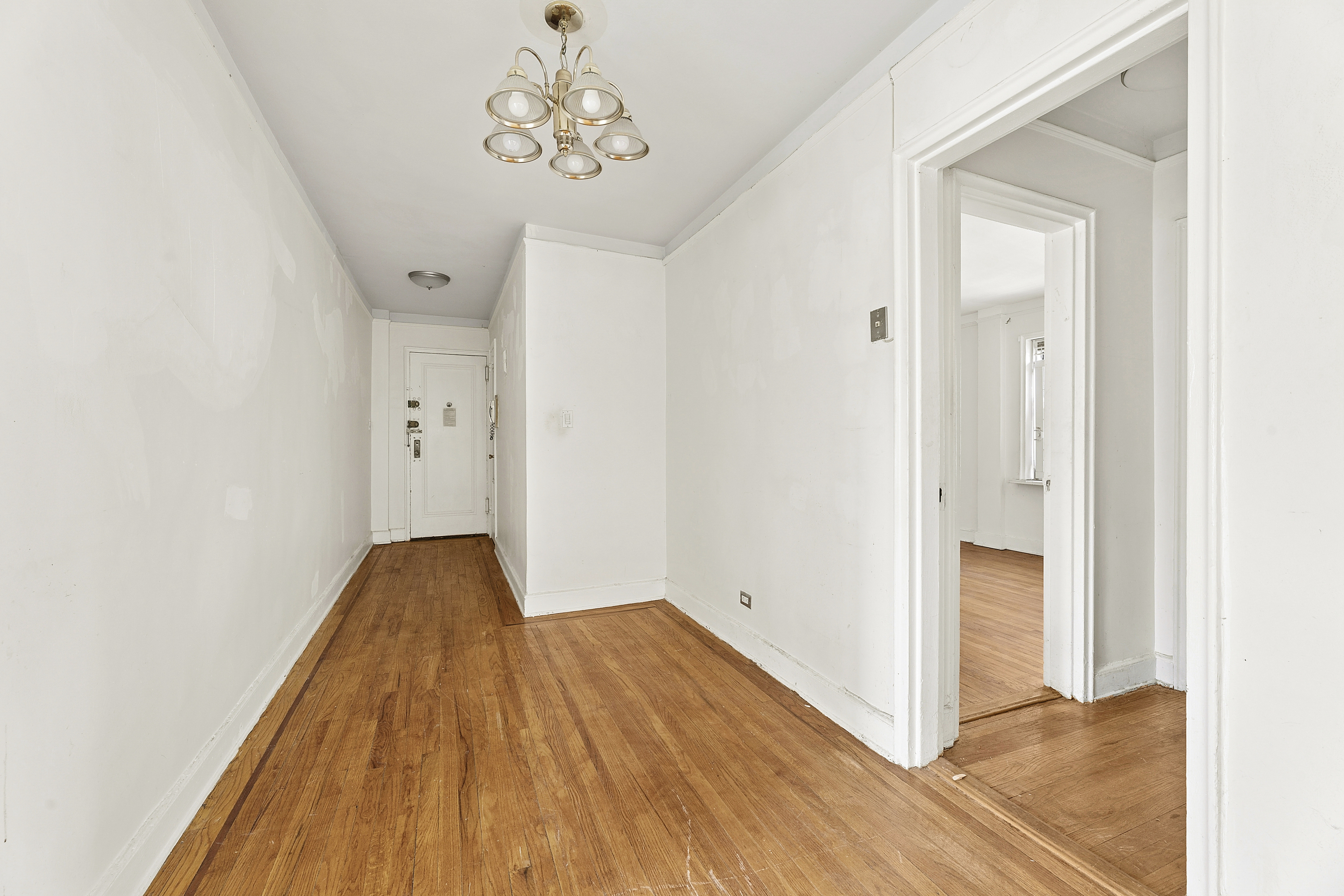 5444 Arlington Avenue, Unit G51 Bronx, NY 10471 - Photo 10 of 16 a view of a hallway with wooden floor
