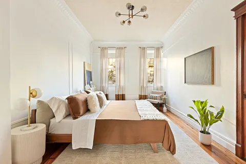 a bedroom with a bed table and couch