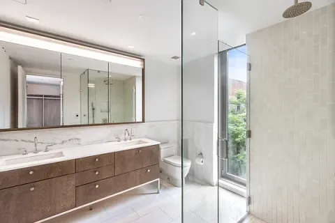 a bathroom with a double vanity sink and a mirror