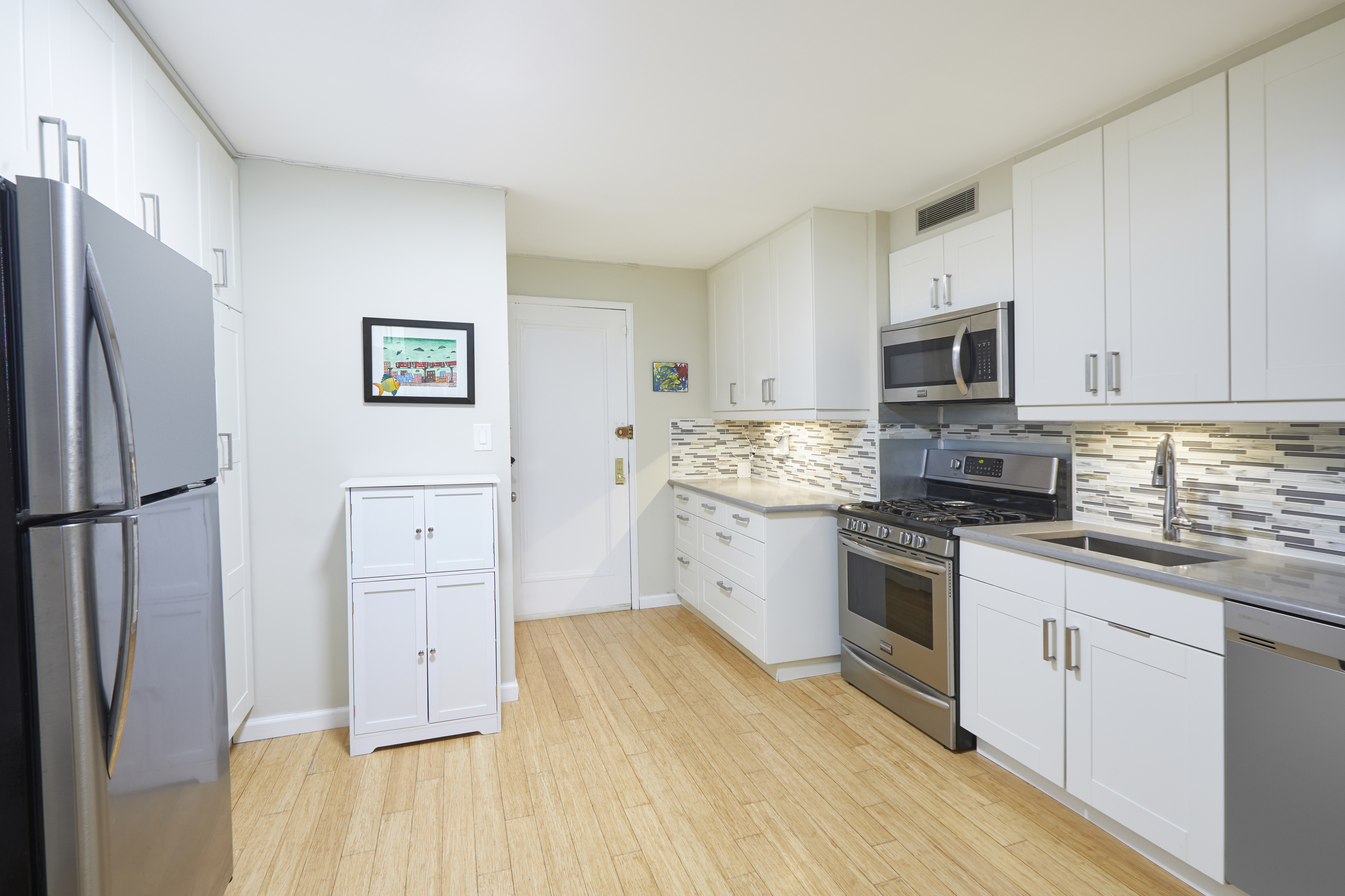 3135 Johnson Avenue, Unit 5D Bronx, NY 10463 - Photo 2 of 7 a kitchen with stainless steel appliances a refrigerator sink and cabinets