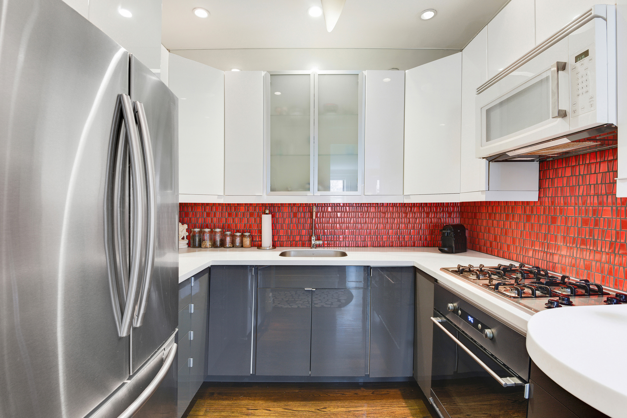 253 West 16th Street, Unit 3A Manhattan, NY 10011 - Photo 6 of 13 a kitchen with stainless steel appliances granite countertop a stove a refrigerator and a sink
