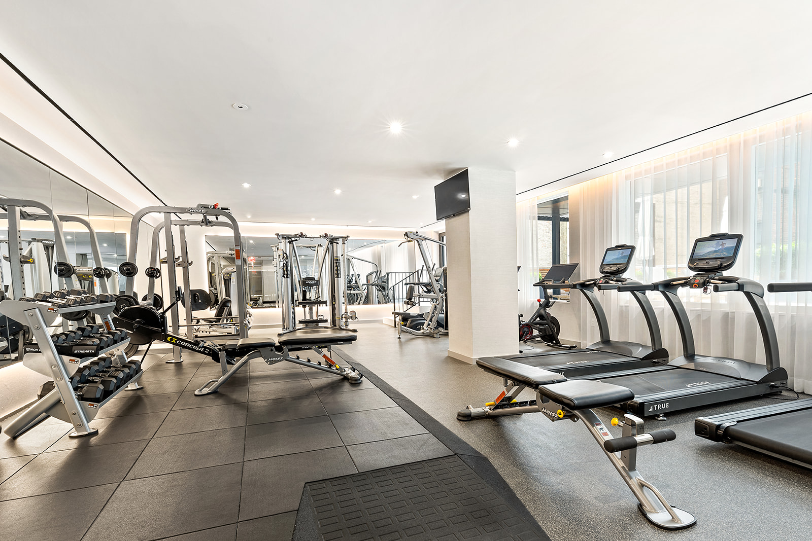 150 East 23rd Street, Unit 5D Manhattan, NY 10010 - Photo 9 of 12 a living room with lots of furniture and windows