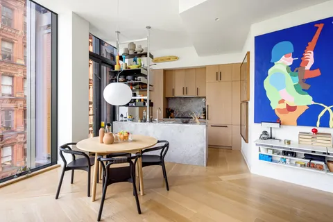 a view of a dining room with furniture and chandelier