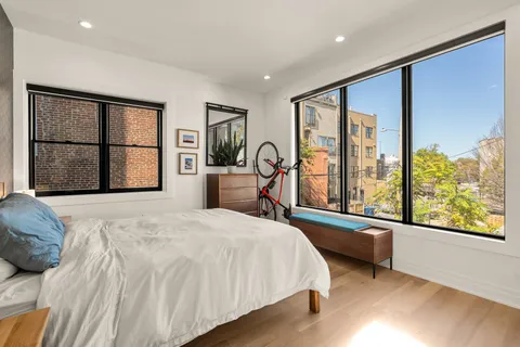 a bedroom with a large bed and a large window