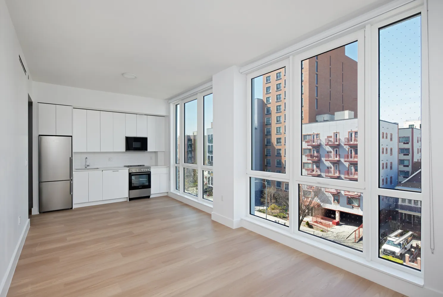 a large kitchen with a stove and a refrigerator