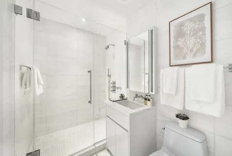 a bathroom with a shower sink and mirror