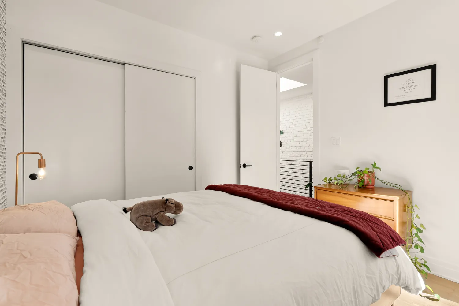 a bedroom with a bed and a painting