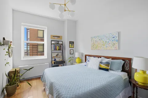 a bed room with a bed and a chair