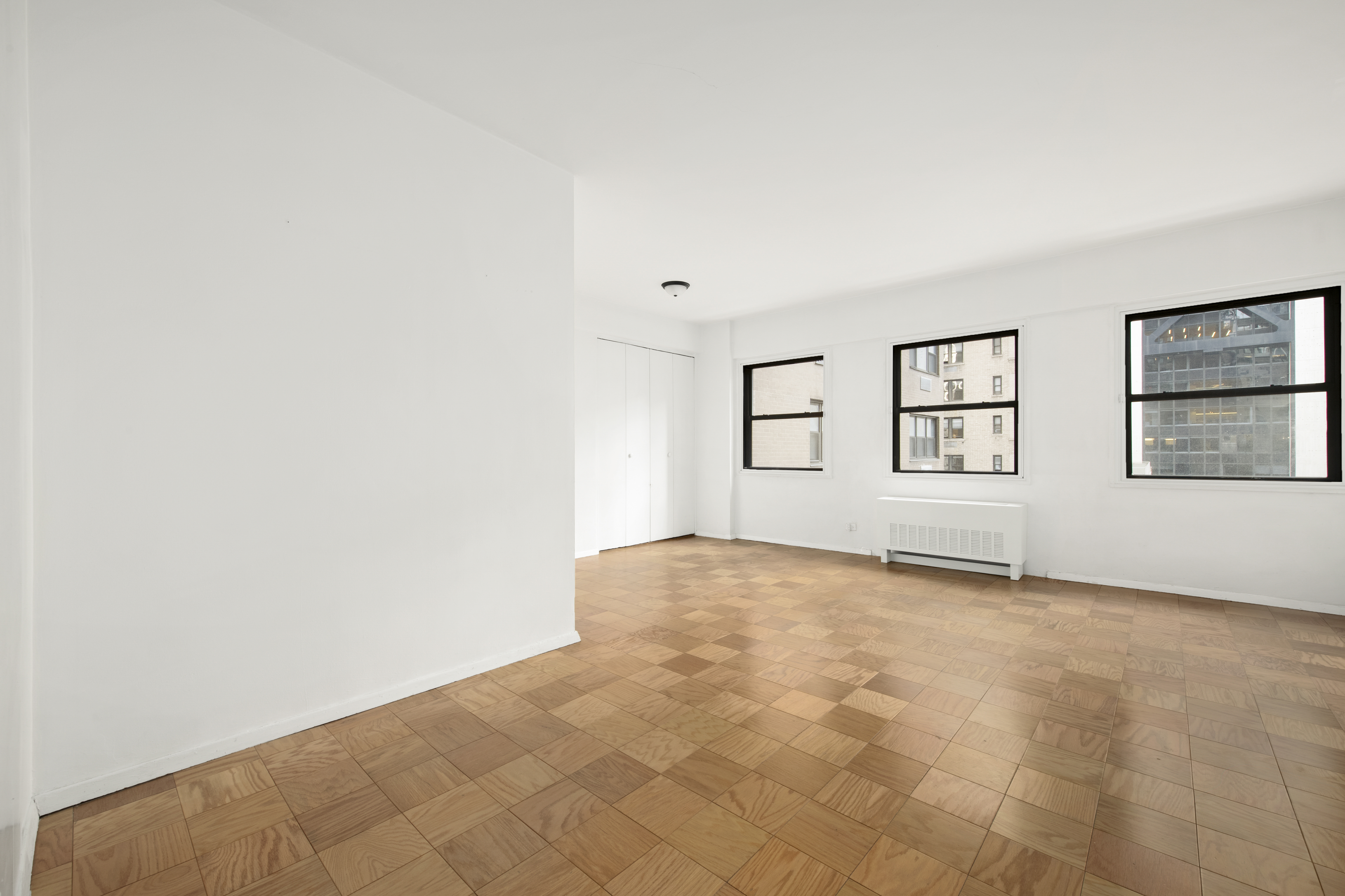 58 West 58th Street, Unit 10D Manhattan, NY 10019 - Photo 6 of 10 an empty room with windows
