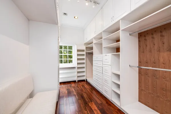 a view of walk in closet with empty racks