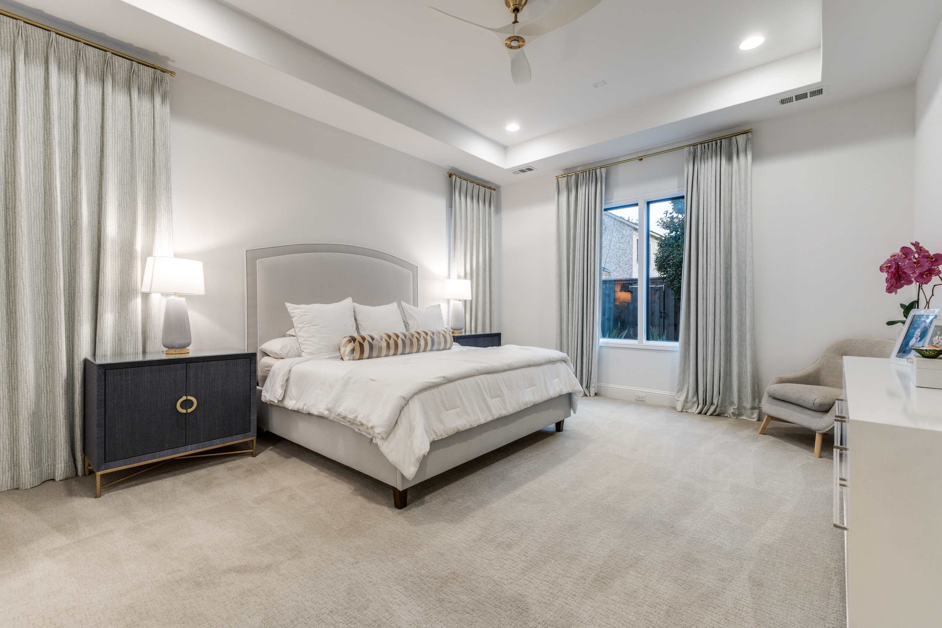 4042 Dunhaven Road Dallas, TX 75220 - Photo 19 of 34 a bedroom with a bed and a chandelier