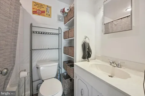 a bathroom with a toilet sink and mirror
