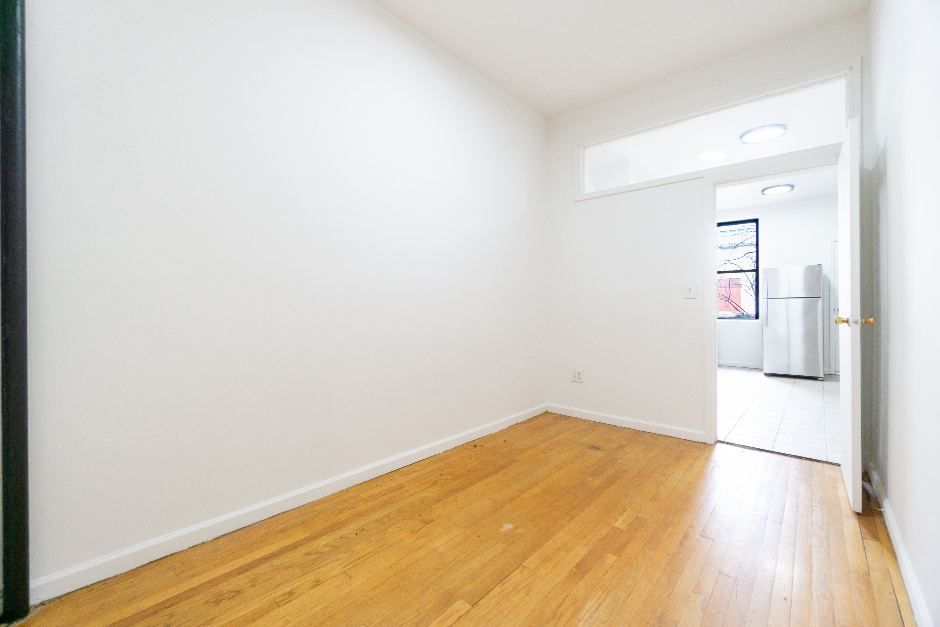 215 East 5th Street, Unit 3 Manhattan, NY 10003 - Photo 12 of 25 a view of a room with wooden floor