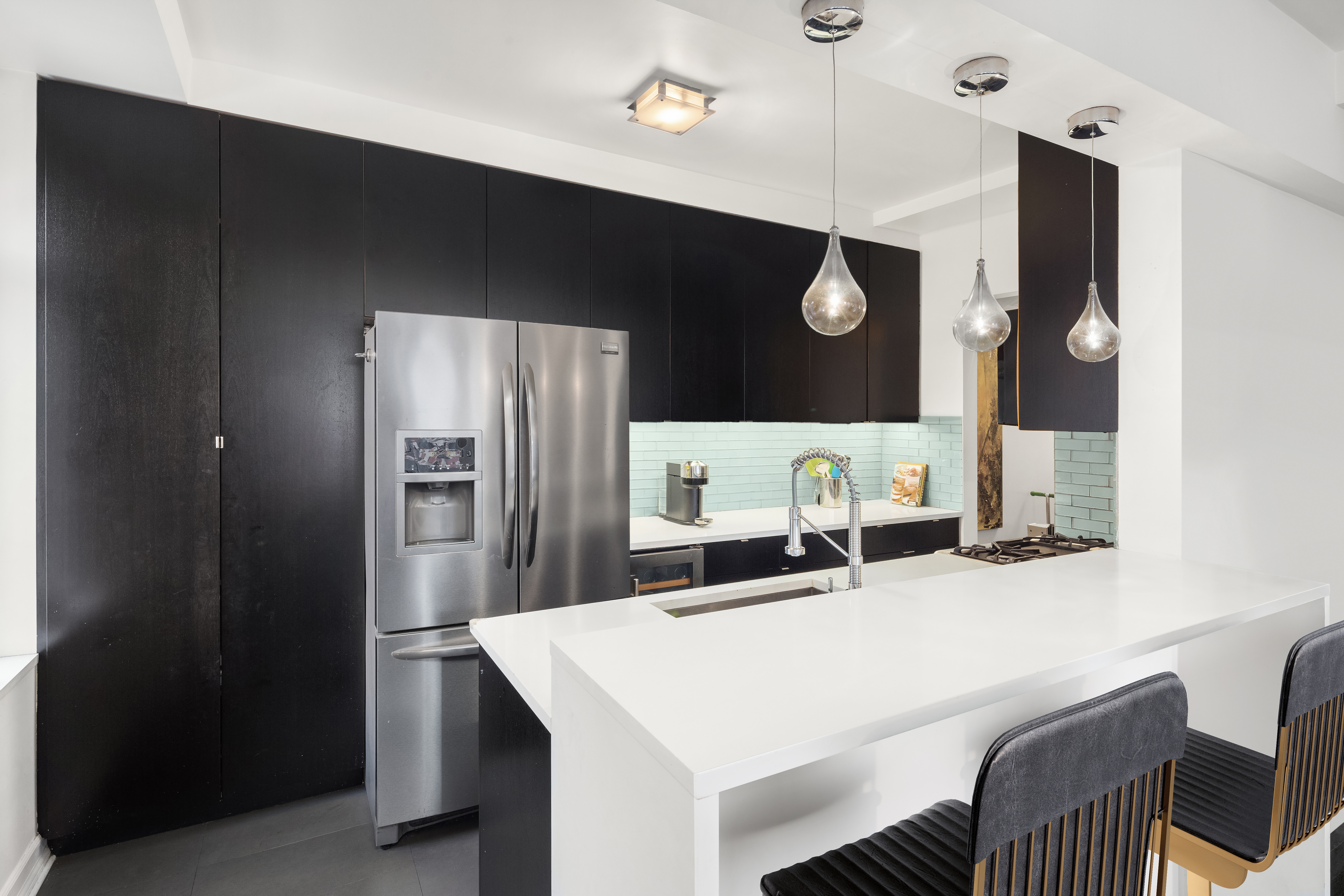 470 West 24th Street, Unit 2C Manhattan, NY 10011 - Photo 4 of 15 a kitchen with a table and refrigerator