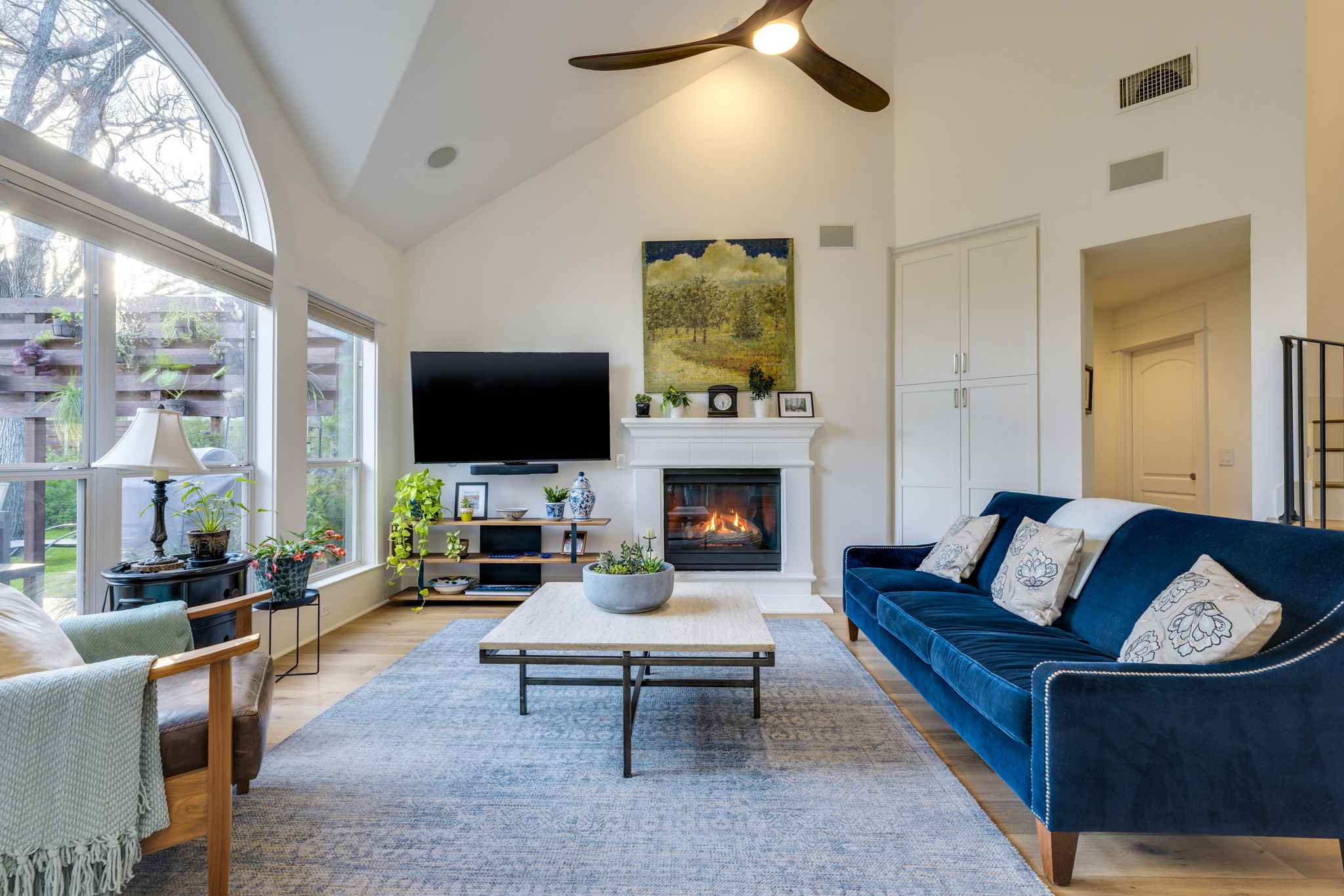 109 West Spring Drive Austin, TX 78746 - Photo 6 of 22 a living room with furniture a flat screen tv and a fireplace