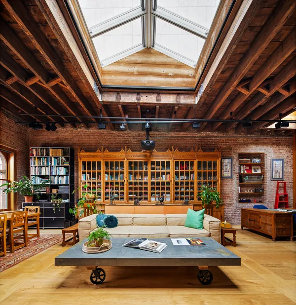 a living room with furniture pool table and a fireplace