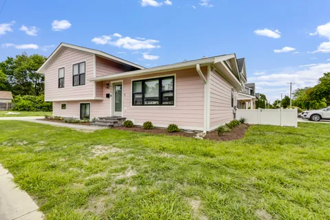 a front view of house with yard and green space