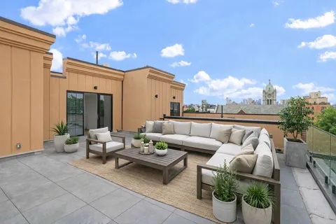 a living room with furniture and a potted plant