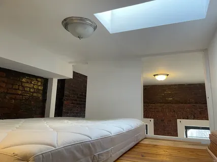 a spacious bedroom with a bed and walk in closet