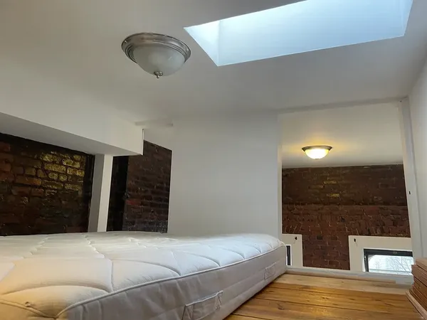 a spacious bedroom with a bed and walk in closet