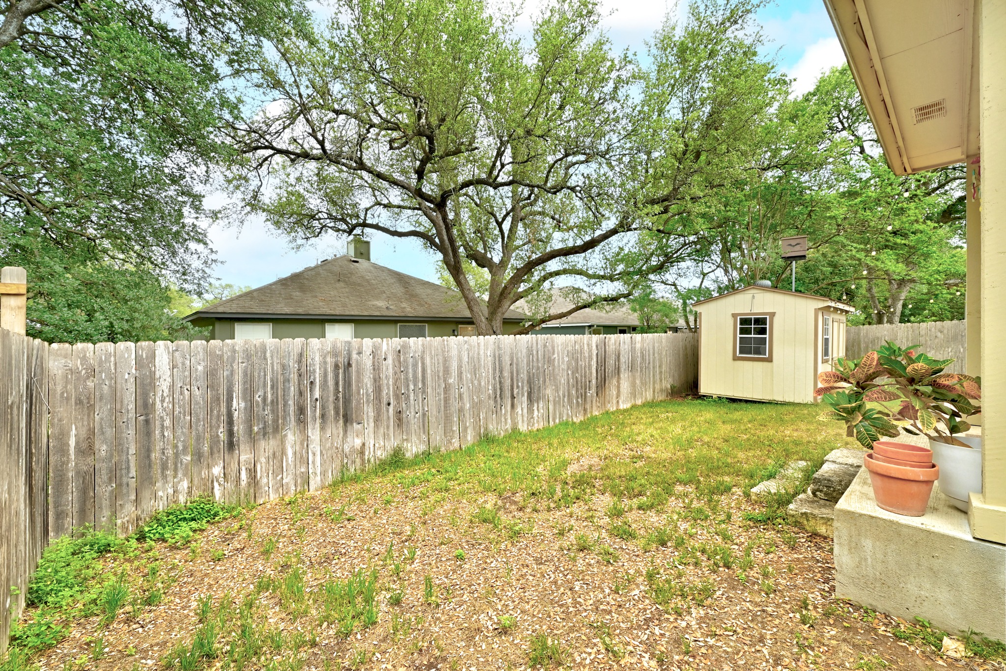8901 Frock Court Austin, TX 78748 - Photo 28 of 28 a backyard of a house with a table and chair under an umbrella