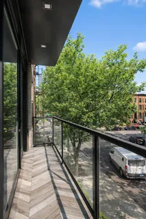 a view of a balcony with wooden floor