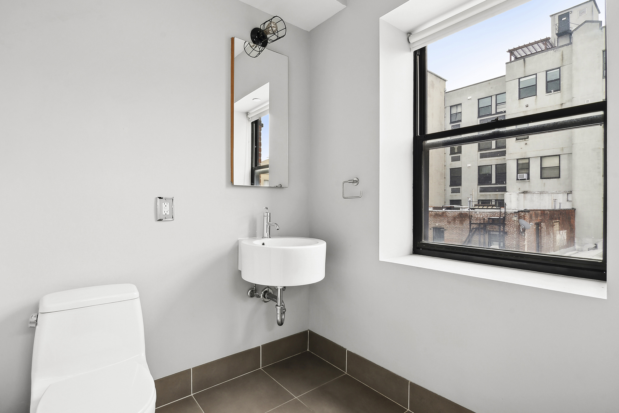 364 Manhattan Avenue, Unit 4G Brooklyn, NY 11211 - Photo 11 of 13 a bathroom with a sink and a mirror