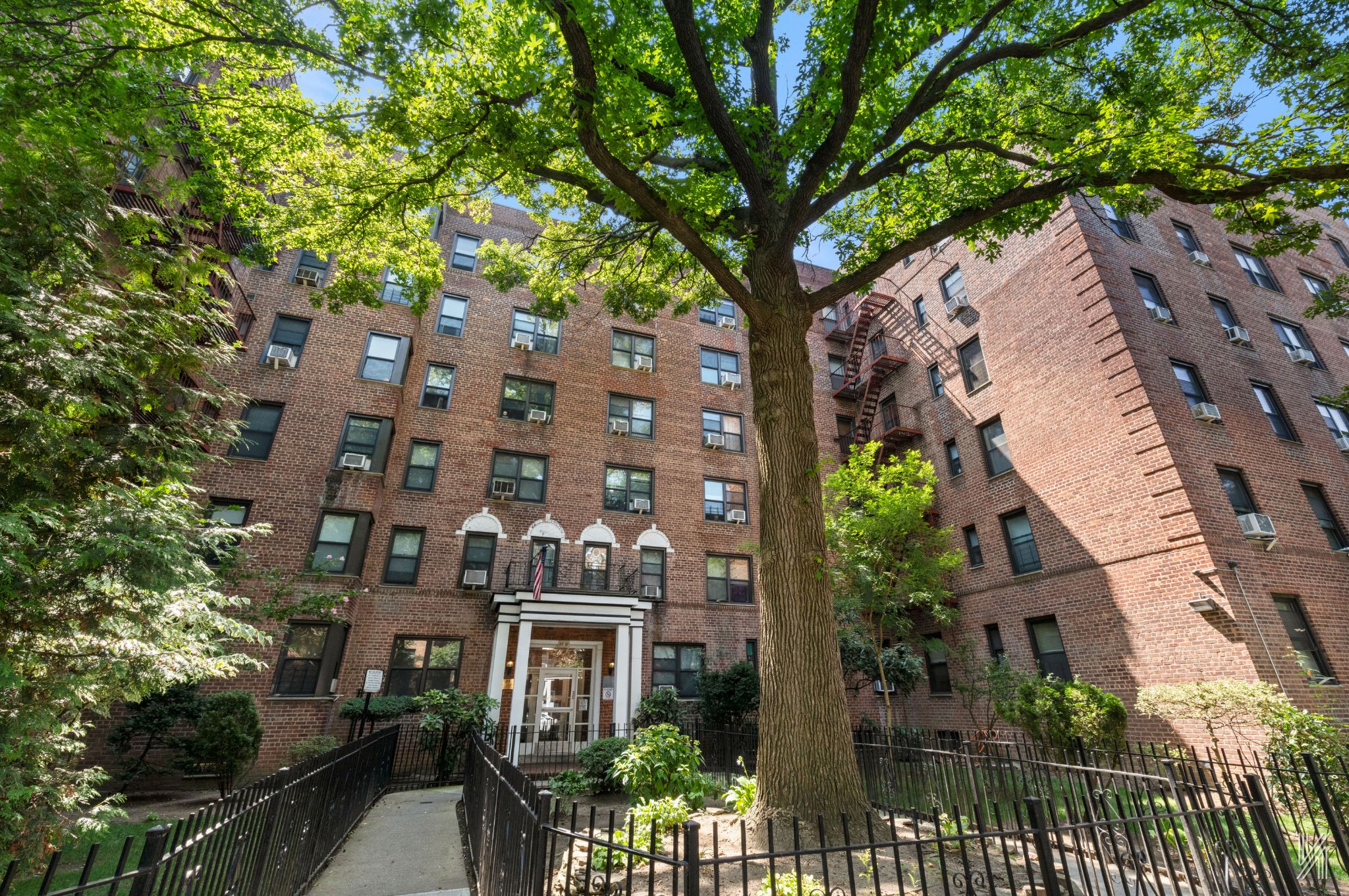 an aerial view of a residential apartment building with a tree