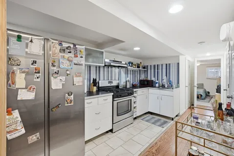 a kitchen with stainless steel appliances a refrigerator sink and cabinets