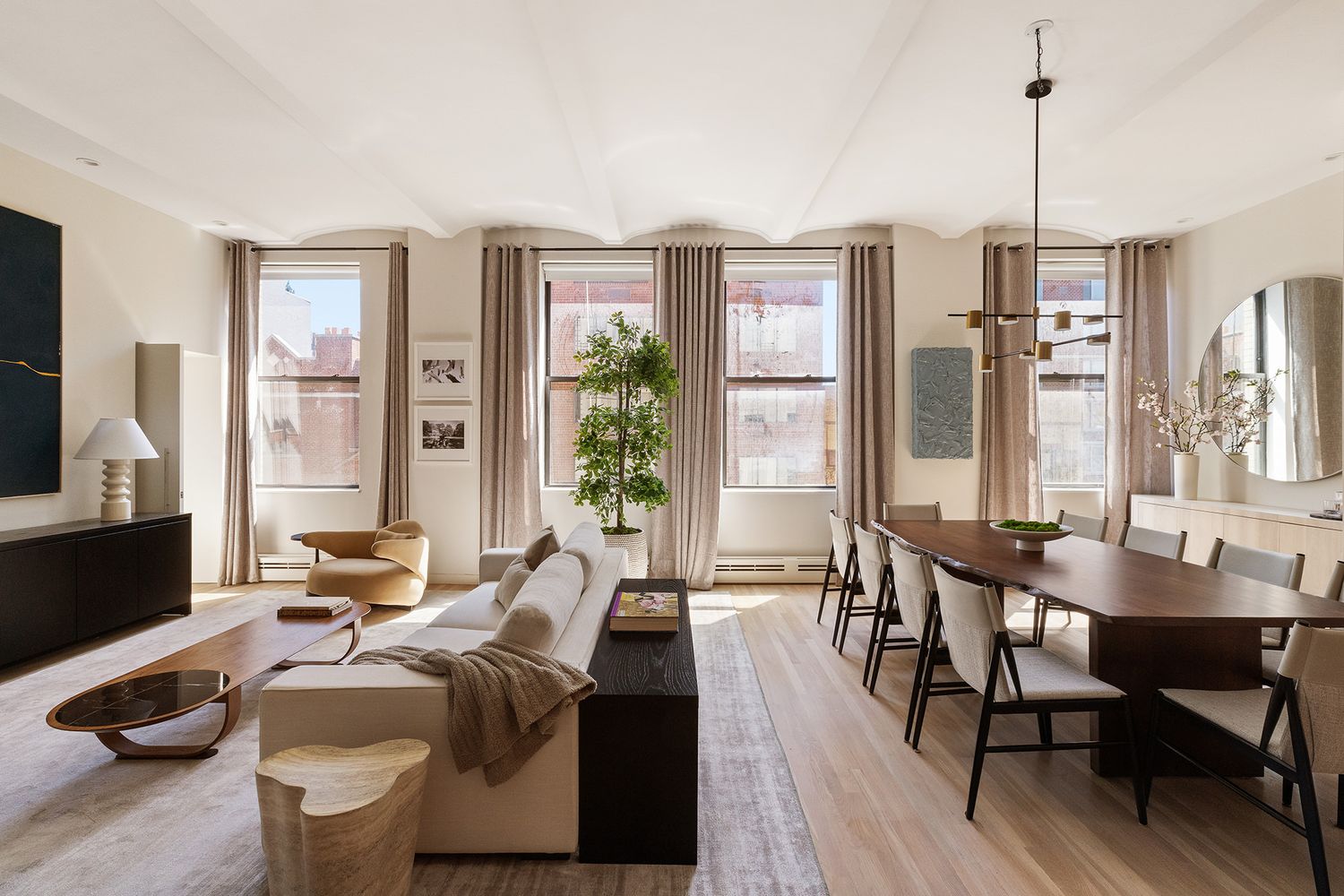 a room with furniture a large window and a chandelier