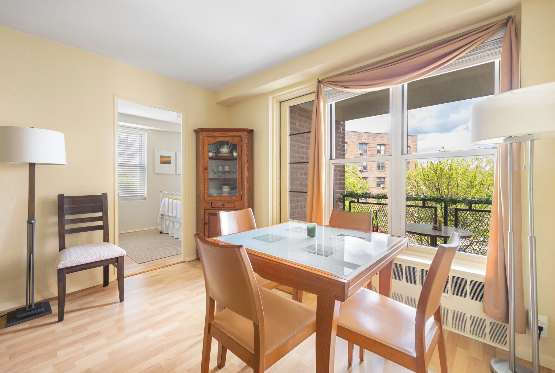35-11 85th Street, Unit 5H Queens, NY 11372 - Photo 5 of 11 a view of a dining room with furniture window and wooden floor