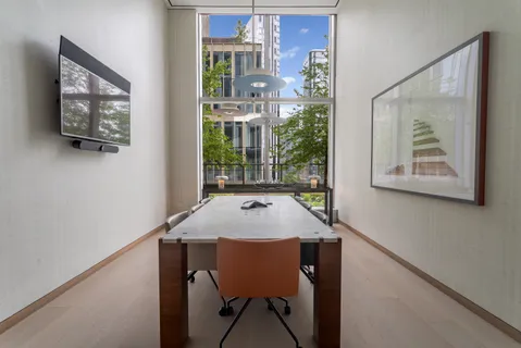a view of a dining room with a table and chairs