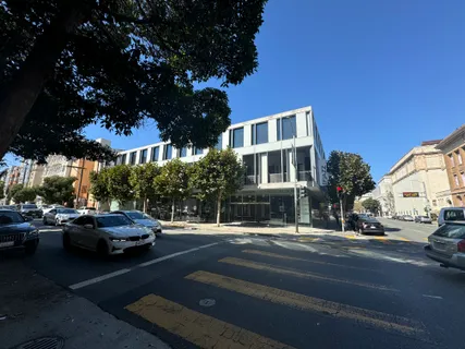 a street view with cars parked on the roadside