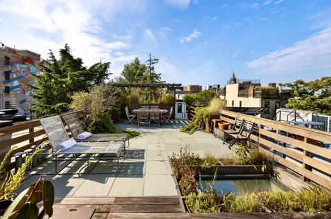 a view of a backyard with sitting area