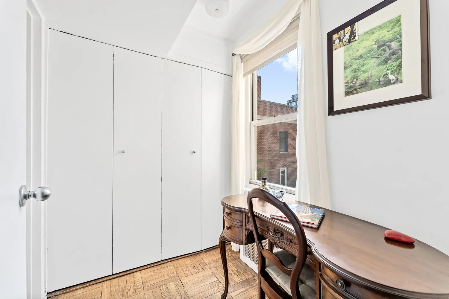 a view of a room with furniture and wooden floor