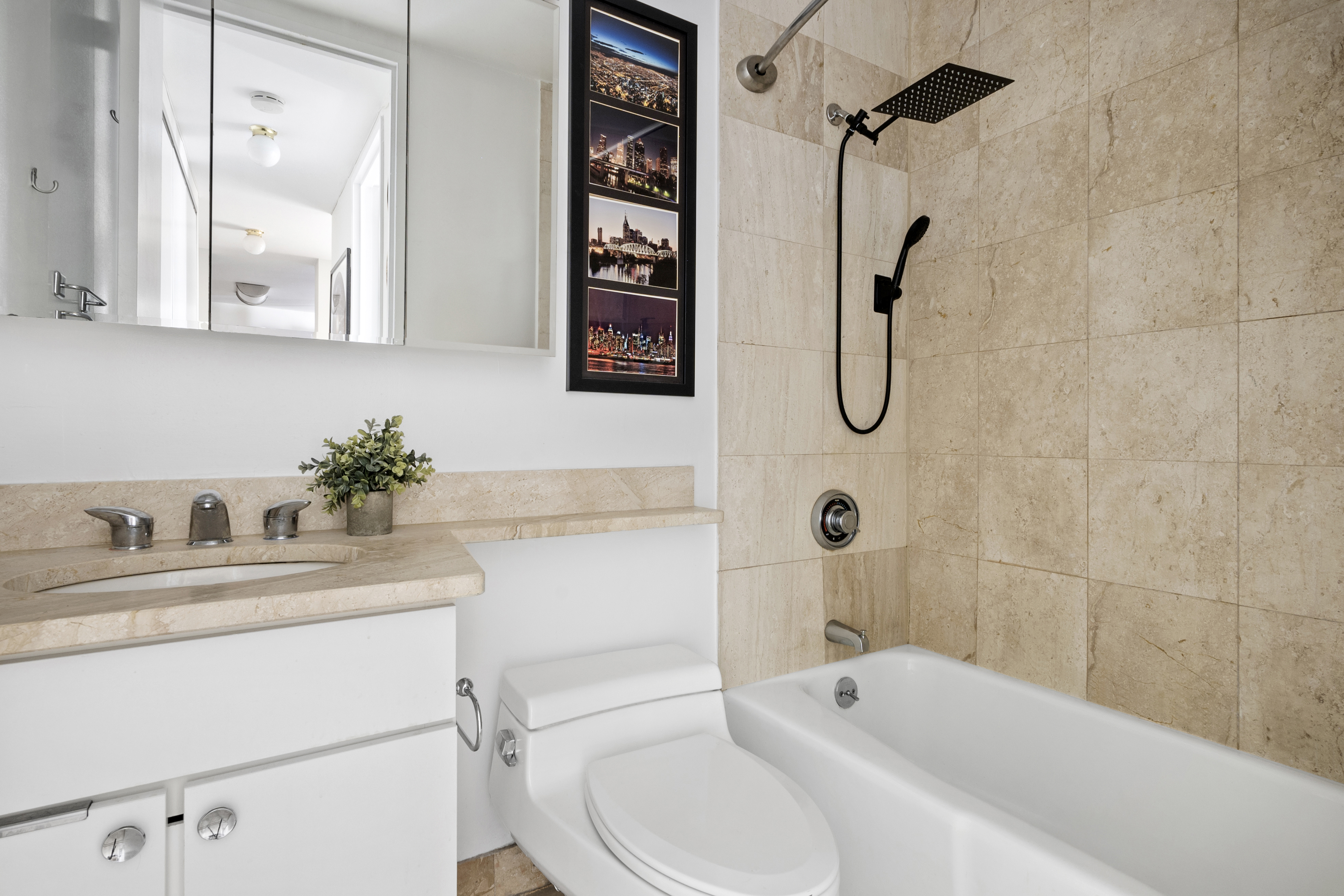 350 West 50th Street, Unit 3LL Manhattan, NY 10019 - Photo 5 of 15 a bathroom with a sink a toilet and shower