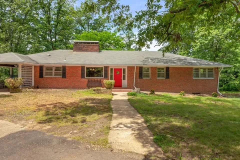 a front view of house with yard and green space