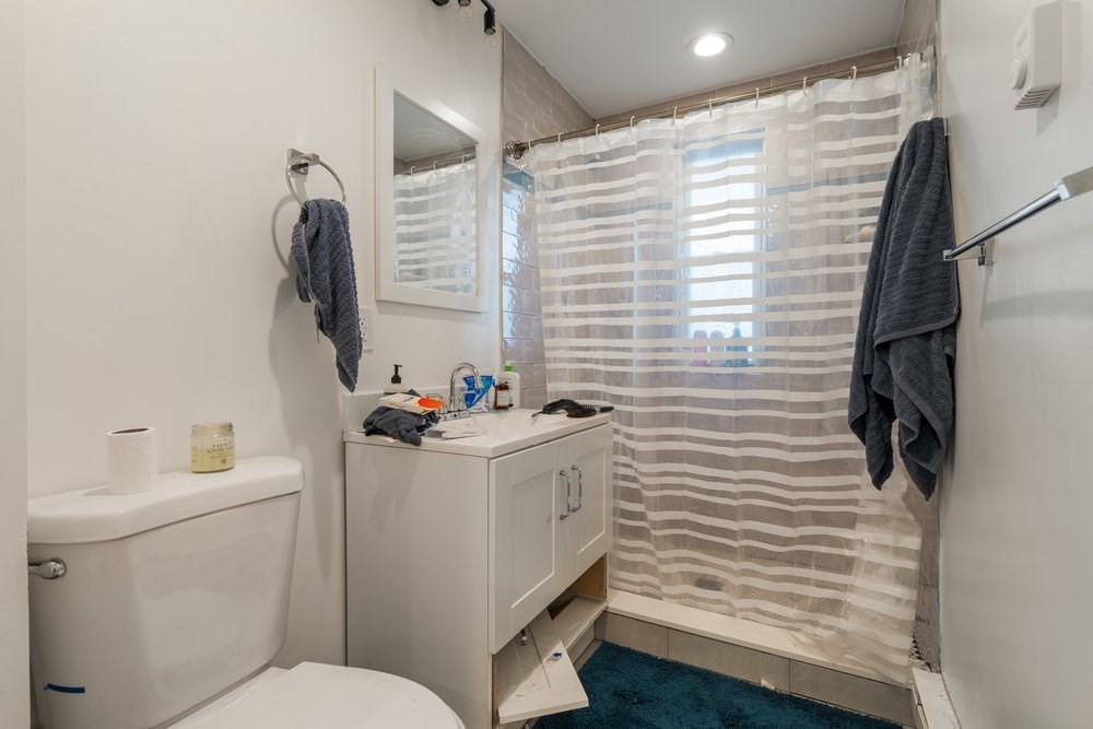 24 Buttonwood Street Boston, MA 02125 - Photo 22 of 43 a bathroom with a sink a toilet and mirror