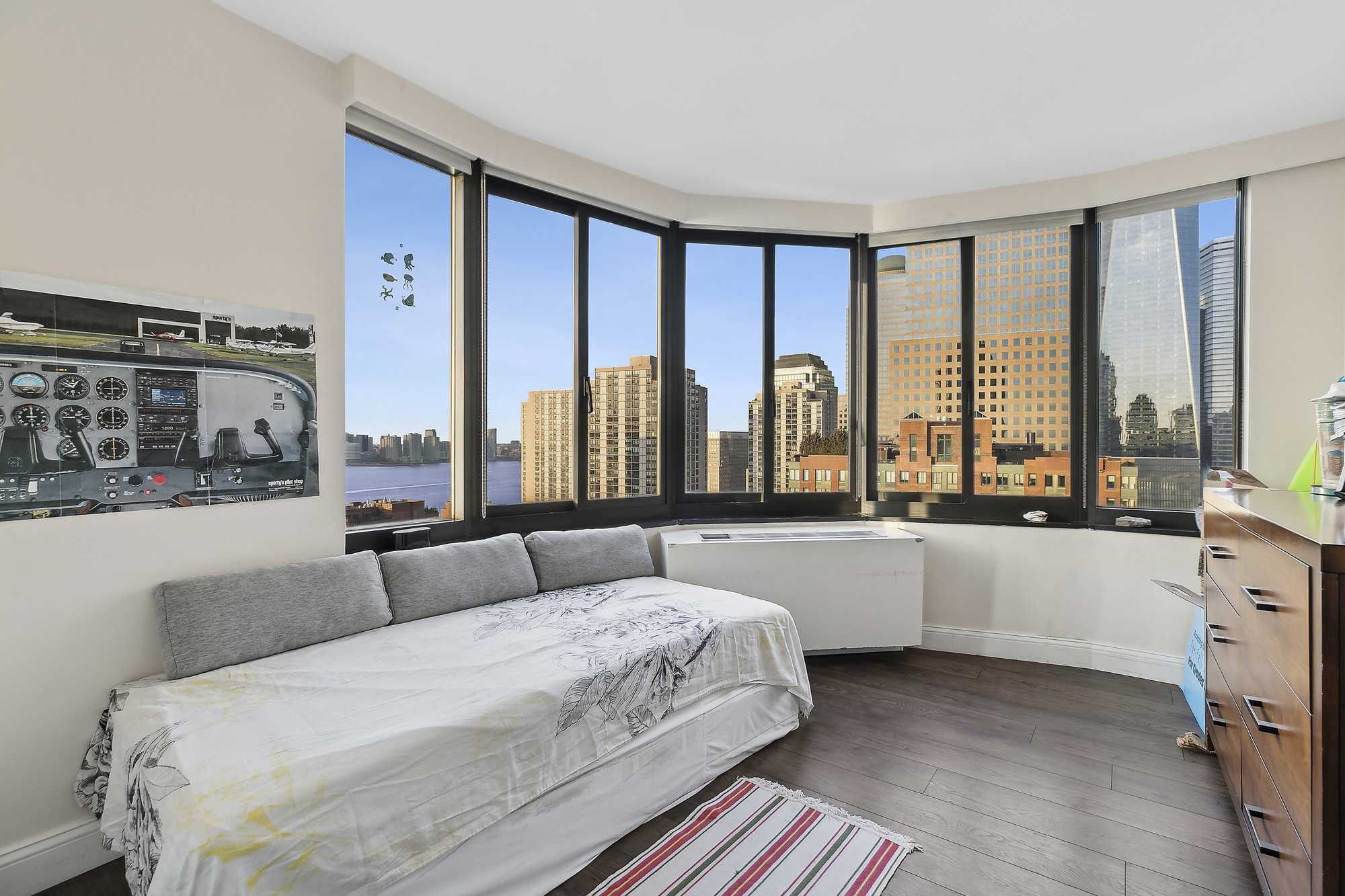 200 Rector Place, Unit 26B Manhattan, NY 10280 - Photo 5 of 8 a bedroom with a large bed and a large window