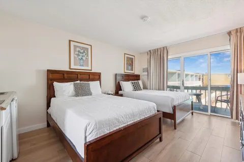 a bedroom with a large bed and a large window