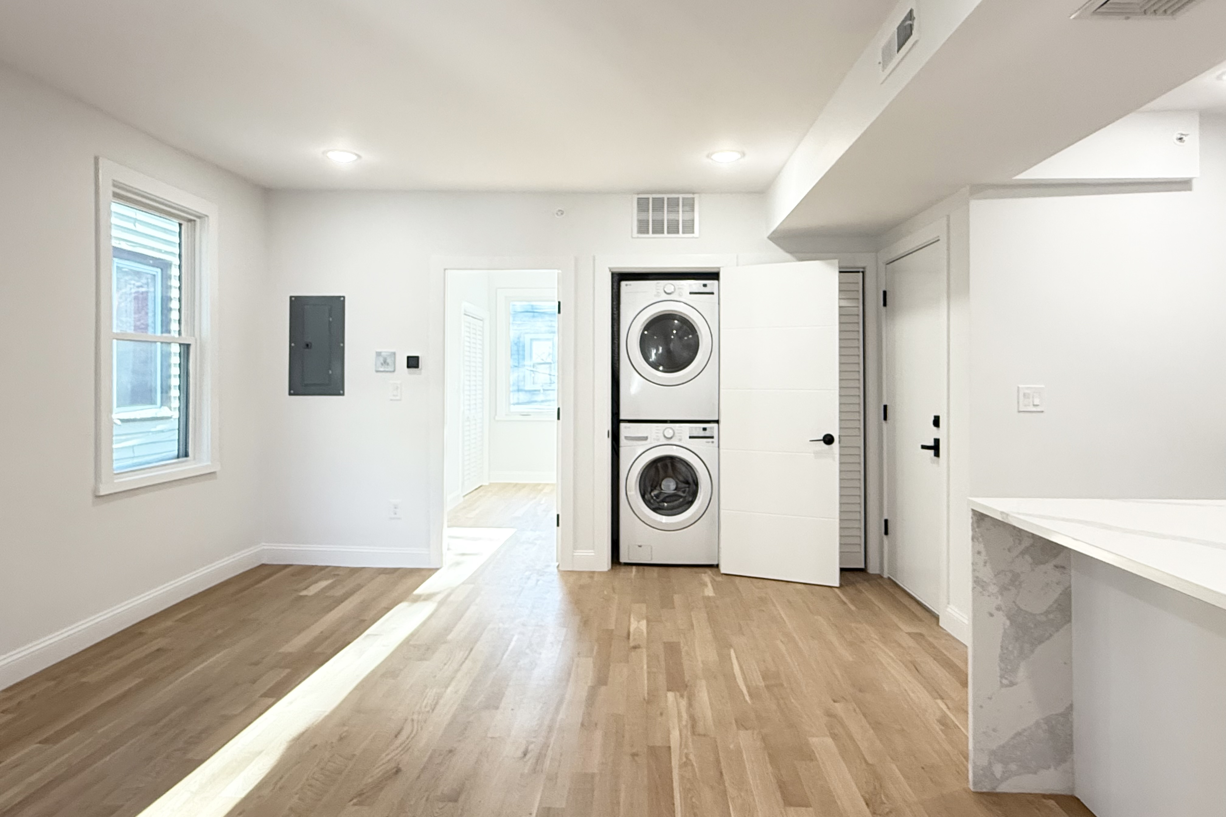 76 Webster Street East Boston, MA 02128 - Photo 3 of 8 a view of a storage & utility room with wooden floor