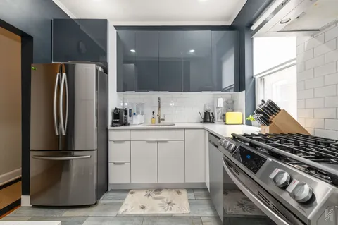 a kitchen with a stove and a refrigerator