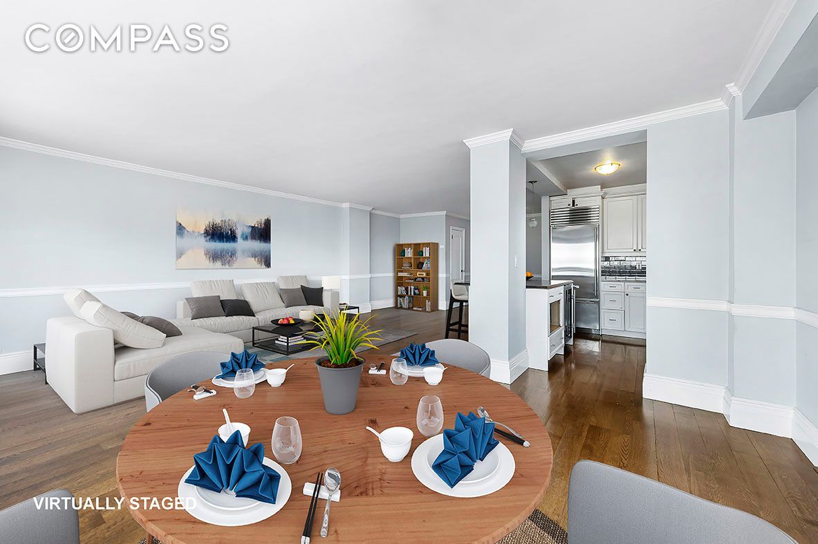 a living room with furniture kitchen view and a table