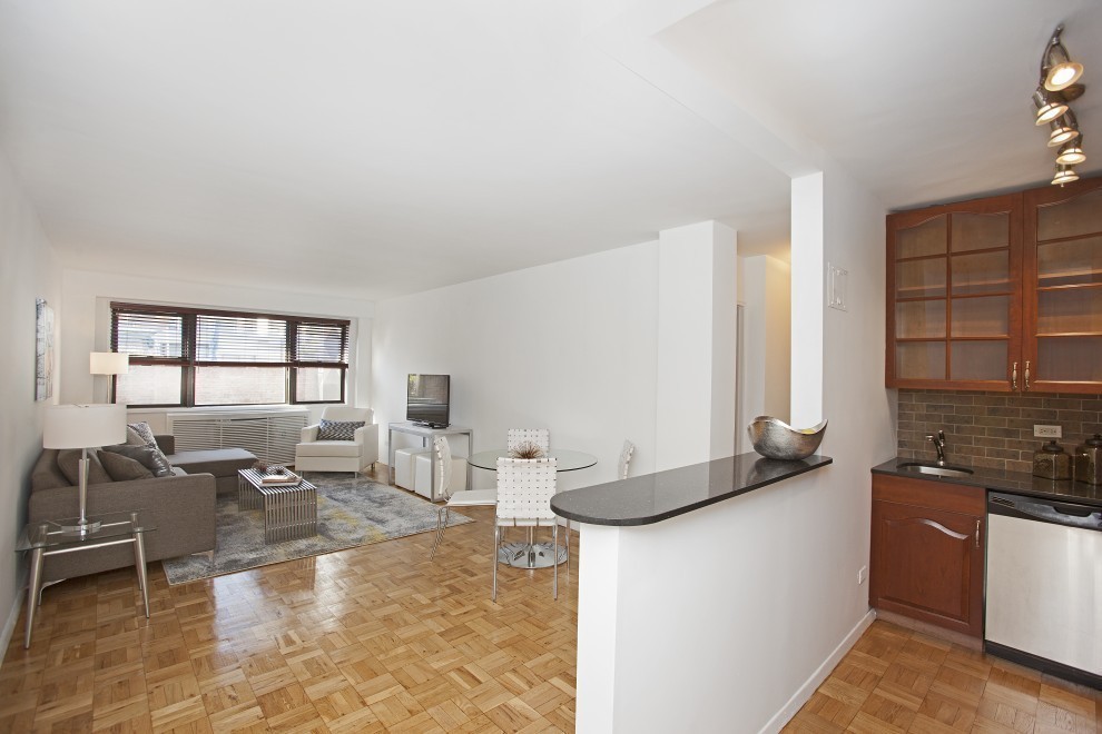 a living room with furniture a flat screen tv and a table