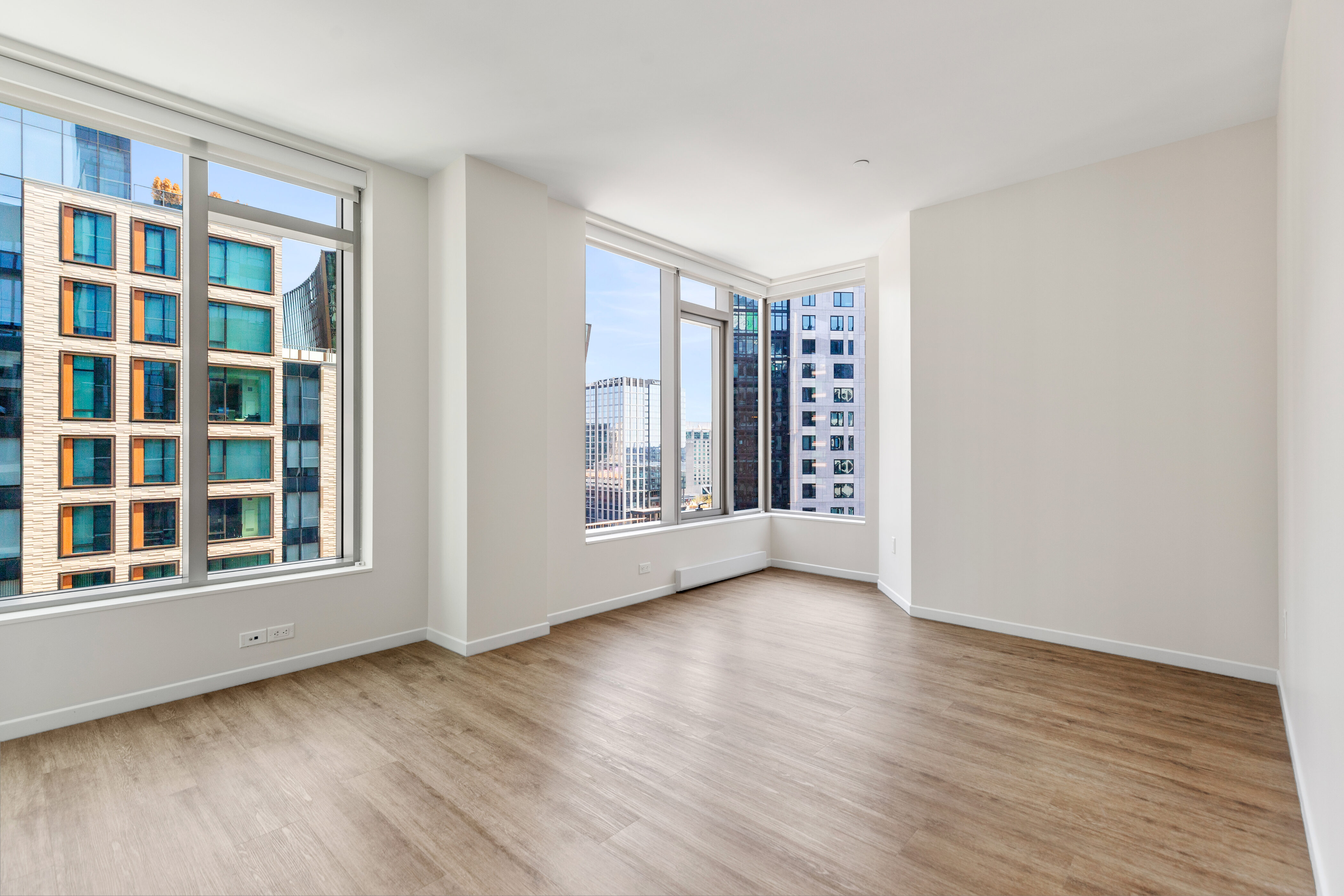131 Seaport Boulevard Boston, MA 02210 - Photo 5 of 11 a view of an empty room with a window and wooden floor